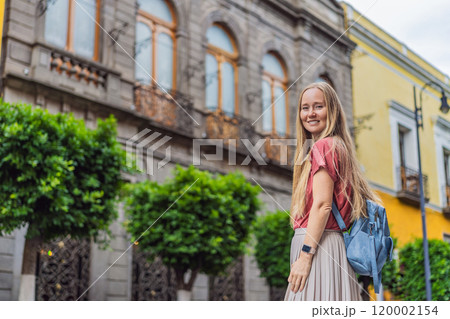 Female tourist walking through the colorful colonial streets of Puebla, Mexico. Travel, cultural exploration, and vibrant architecture concept Female tourist walking through the colorful colonial streets of Puebla, Mexico. Travel, cultural exploration, and vibrant architecture concept 120002154