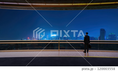 Businessman looking at city skyline at night from balcony 3d rendering Businessman looking at city skyline at night from balcony 3d rendering 120003558