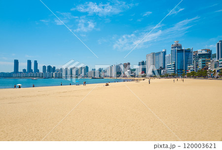 Busan city skyline rising above gwangalli beach crowded with tourists 120003621