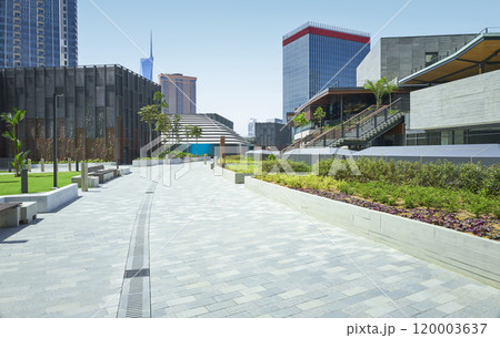 Empty modern city park with benches and skyscrapers 120003637