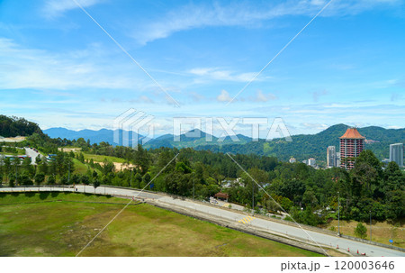 Winding road leading through lush green valley in the genting highlands, malaysia Winding road leading through lush green valley in the genting highlands, malaysia 120003646