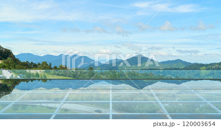 Empty glass floor platform reflecting majestic mountains and sky Empty glass floor platform reflecting majestic mountains and sky 120003654