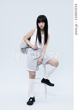 A Korean Woman in Her 20s Poses Sitting on a Chair in a Block Core fashion 120005034