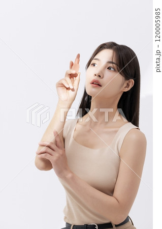 a woman holding a lipstick in the sun a woman holding a lipstick in the sun 120005985