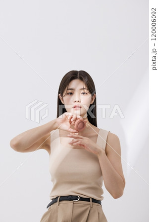 A woman posing with a blusher A woman posing with a blusher 120006092