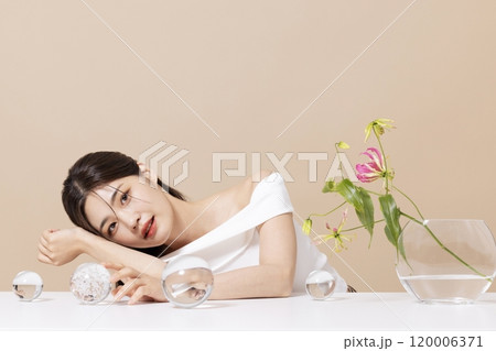 a woman in her 20s in front of a table decorated with flowers a woman in her 20s in front of a table decorated with flowers 120006371