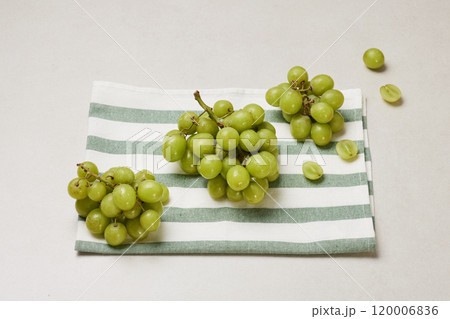 Green grapes neatly placed on a cloth Green grapes neatly placed on a cloth 120006836