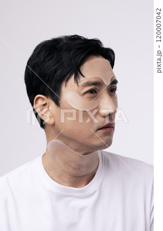 Middleaged man with cosmetic patches on his face Middleaged man with cosmetic patches on his face 120007042
