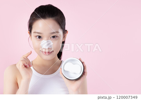 Teenage woman trying out nose pads Teenage woman trying out nose pads 120007349