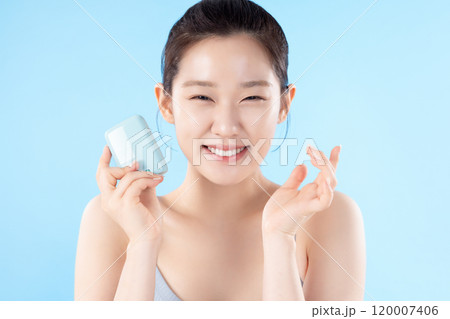 A teenage woman posing with cosmetics A teenage woman posing with cosmetics 120007406