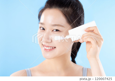 A teenage woman posing with cosmetics A teenage woman posing with cosmetics 120007425