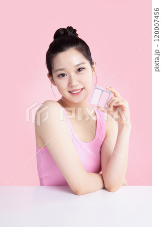 A teenage woman posing with blusher 120007456