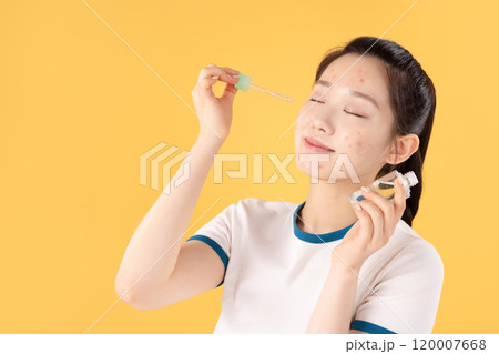 Teenage woman using skincare products to remove skin problems on her face Teenage woman using skincare products to remove skin problems on her face 120007668