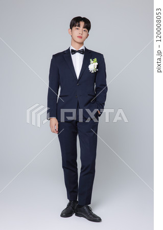 A man in his 20s wearing a suit and taking a wedding photo shoot A man in his 20s wearing a suit and taking a wedding photo shoot 120008053