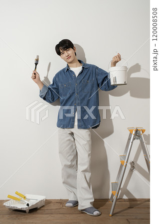 A man in his 20s painting a wall A man in his 20s painting a wall 120008508
