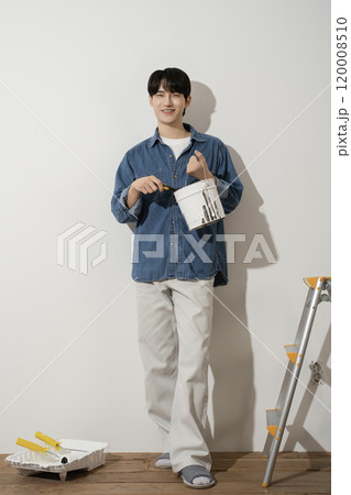 A man in his 20s painting a wall A man in his 20s painting a wall 120008510