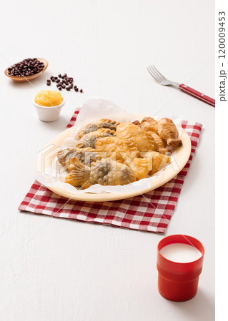 Red bean bungeoppang puff pastry and cream bungeoppang beautifully plated on a red checkered tablecloth Red bean bungeoppang puff pastry and cream bungeoppang beautifully plated on a red checkered tablecloth 120009453
