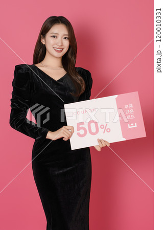 A woman in her 20s posing with a 50 percent discount coupon 120010331
