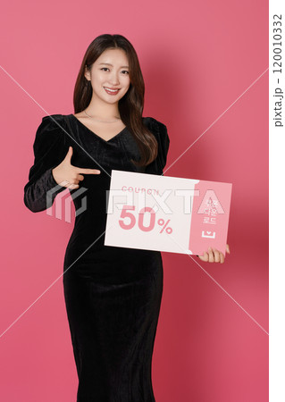A woman in her 20s posing with a 50 percent discount coupon A woman in her 20s posing with a 50 percent discount coupon 120010332