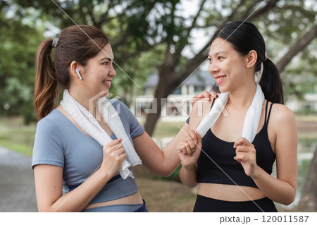 Young Female Friends Exercising Together in the Park, Enjoying a Healthy Lifestyle and Fitness Routine Outdoors 120011587