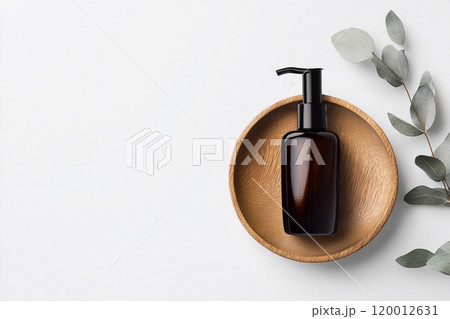 Amber cosmetic dispenser bottle on a wooden surface against a clean, white background. Minimalistic banner ideal for promoting skincare or beauty products in a natural, elegant setting 120012631