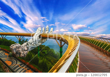 Golden Bridge of the Hand of Gods at Sun World Ba Na Hills amusement Park in Da Nang in Vietnam in summer Golden Bridge of the Hand of Gods at Sun World Ba Na Hills amusement Park in Da Nang in Vietnam in summer 120012705