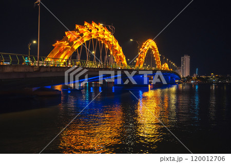 Dragon Bridge over the Han River is a famous landmark in Da Nang in Vietnam at night with golden illuminated Dragon Bridge over the Han River is a famous landmark in Da Nang in Vietnam at night with golden illuminated 120012706