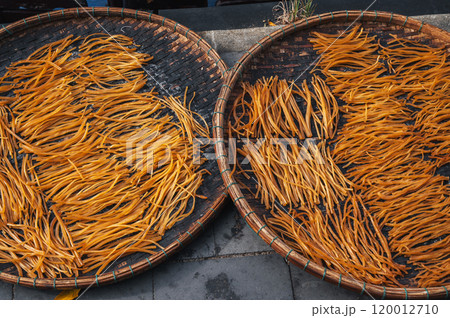 Dried fish sticks on market in Vietnam in Asia 120012710