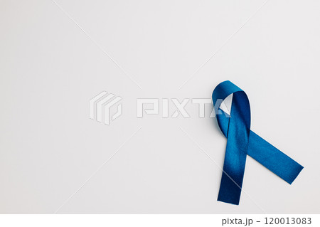 A bright blue ribbon, a symbol of world diabetes day on November 14, isolated on white. Copy space for messages of patient support and medical care. 120013083