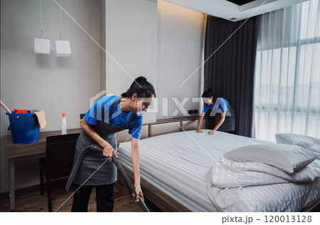 cleaning service woman worker clean bedroom at home. housekeeper cleaner feel happy and make bed look neat. housework and housekeeping cleaning service 120013128