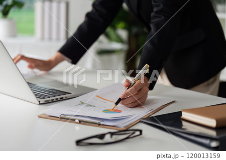 Accountant working on financial data analysis dashboard on paper as marketing indication for business strategic planning 120013159