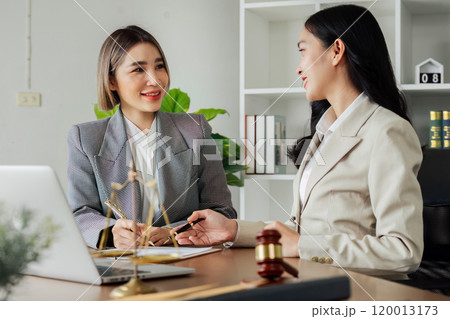 Lawyer working with client discussing contract document in office, consulting to help customer 120013173