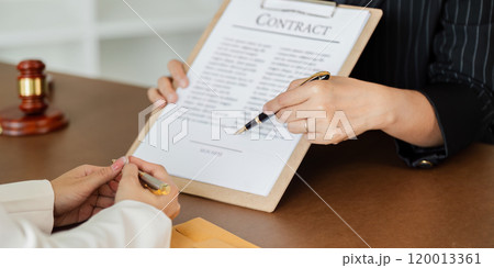 Hand of lawyer pointing at document agreement, contract for businessperson, client signing contract Hand of lawyer pointing at document agreement, contract for businessperson, client signing contract 120013361
