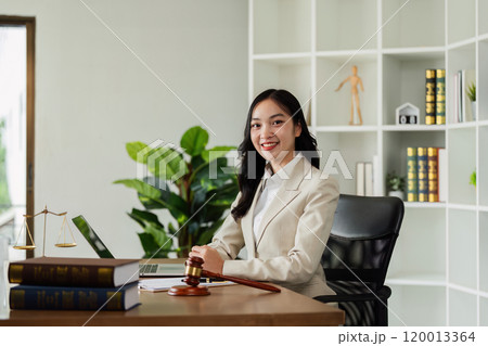 Woman lawyer confident working about ducument at desk and looking at camera 120013364
