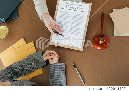Hand of lawyer pointing at document agreement, contract for businessperson, client signing contract Hand of lawyer pointing at document agreement, contract for businessperson, client signing contract 120013365