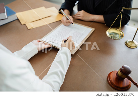 Hand of lawyer pointing at document agreement, contract for businessperson, client signing contract Hand of lawyer pointing at document agreement, contract for businessperson, client signing contract 120013370