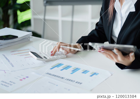Business finance concept, Business woman using calculator to calculate business data at office Business finance concept, Business woman using calculator to calculate business data at office 120013384