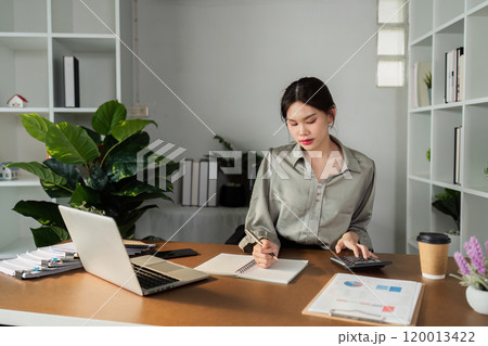 Business finance concept, Business woman using calculator to calculate business data at office Business finance concept, Business woman using calculator to calculate business data at office 120013422