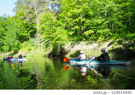 Group kayak trip for seigneur and senora . An elderly couple And adult rowing boat on the river, a water hike, a summer adventure. Age-related sports, mental youth and health, tourism, active old age 120014940
