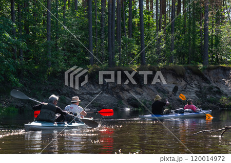 Group kayak trip for seigneur and senora . An elderly couple And adult rowing boat on the river, a water hike, a summer adventure. Age-related sports, mental youth and health, tourism, active old age Group kayak trip for seigneur and senora . An elderly couple And adult rowing boat on the river, a water hike, a summer adventure. Age-related sports, mental youth and health, tourism, active old age 120014972