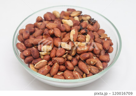 roasted and salted peanuts in a bowl. Isolated on a white background. roasted and salted peanuts in a bowl. Isolated on a white background. 120016709