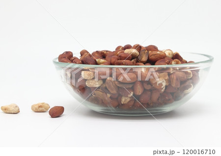 roasted and salted peanuts in a bowl. Isolated on a white background. roasted and salted peanuts in a bowl. Isolated on a white background. 120016710