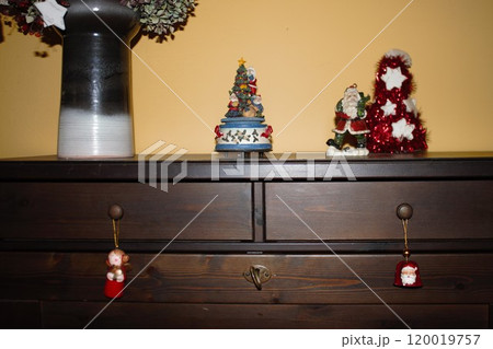 wooden cabinet with Christmas decorations and christmas muggle carousel 120019757