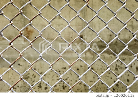 Wire fence with cement wall background. 120020118