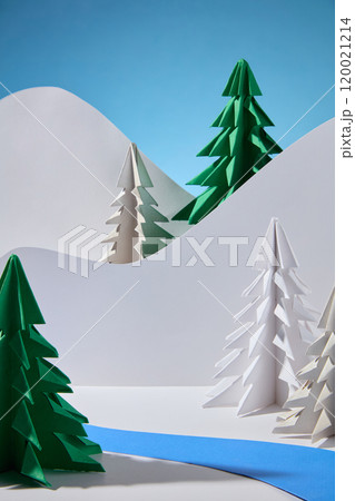 A template picture of the winter concept shows an empty space to display products, surrounded by various pine papers and a river of green paper, behind is a hill of white paper on a blue background. 120021214
