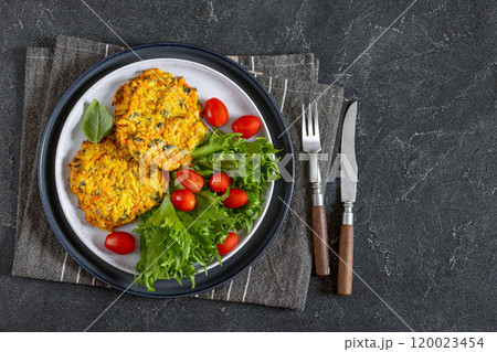 pumpkin carrot potato patties on plate, top view pumpkin carrot potato patties on plate, top view 120023454