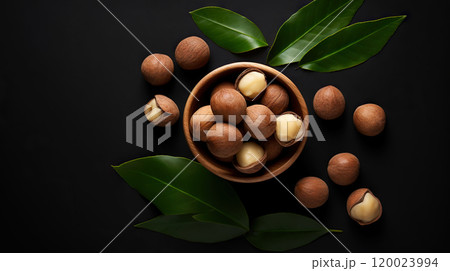 Large group of Macadamia nuts in a bowl on dark background with leaves. Food backdrop. Generative AI Large group of Macadamia nuts in a bowl on dark background with leaves. Food backdrop. Generative AI 120023994