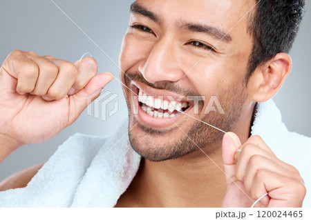 Man, hands and teeth in studio for floss, hygiene and cleaning or grooming for daily routine. Male person, mouth and dental care in morning for wellness, results and gingivitis by gray background 120024465