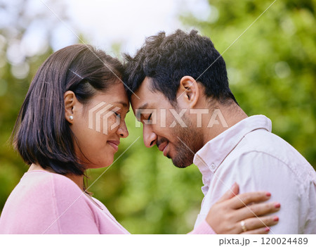Couple, eyes closed and forehead or happy in nature, smile and commitment together for relationship bonding. Love, romance and married people in park, trust and support with partners for intimacy 120024489