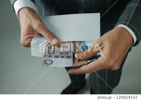 businessman takes out forints from an envelope 120024532
